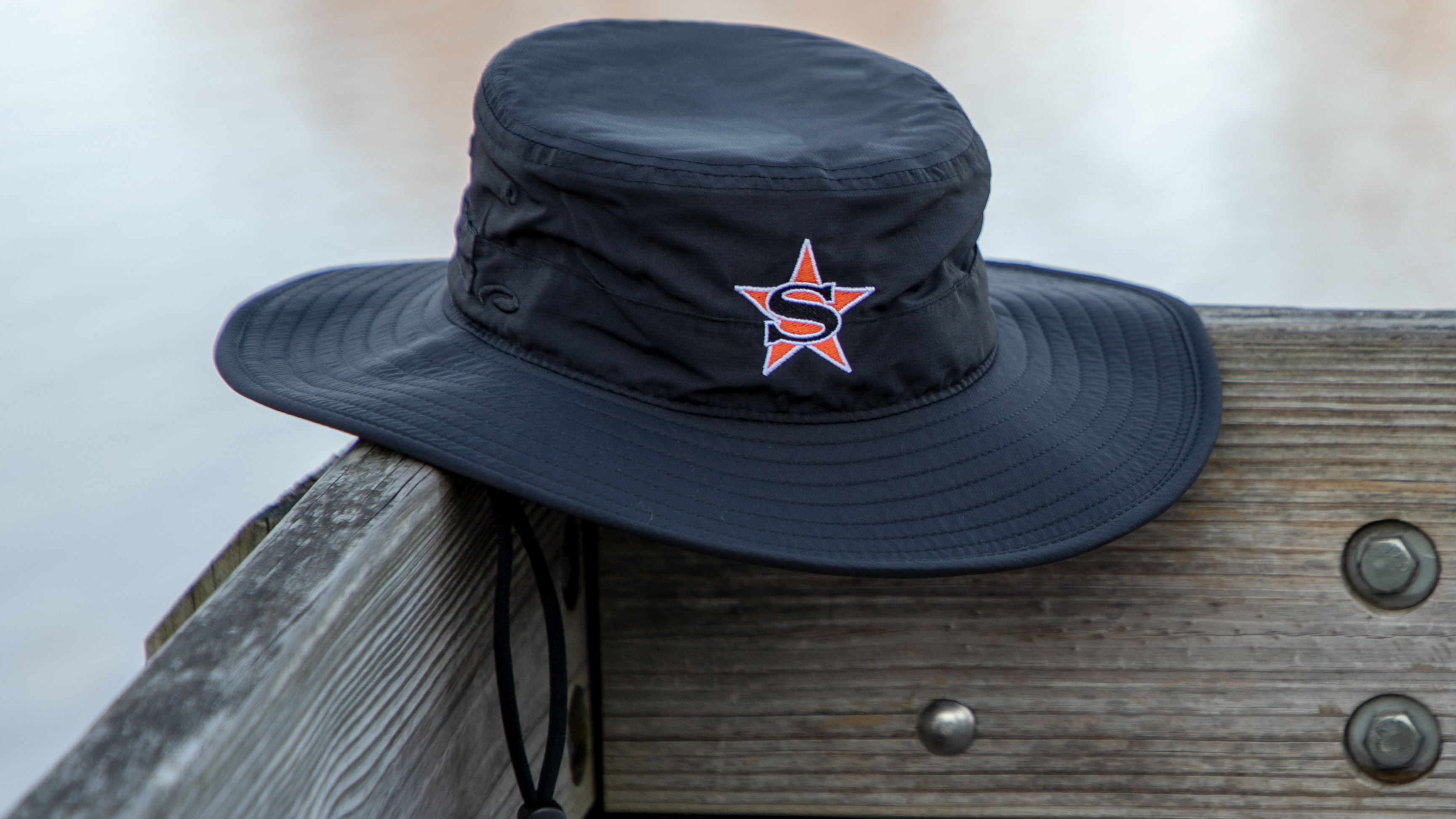 Shademaker II bucket hat sitting on porch rail