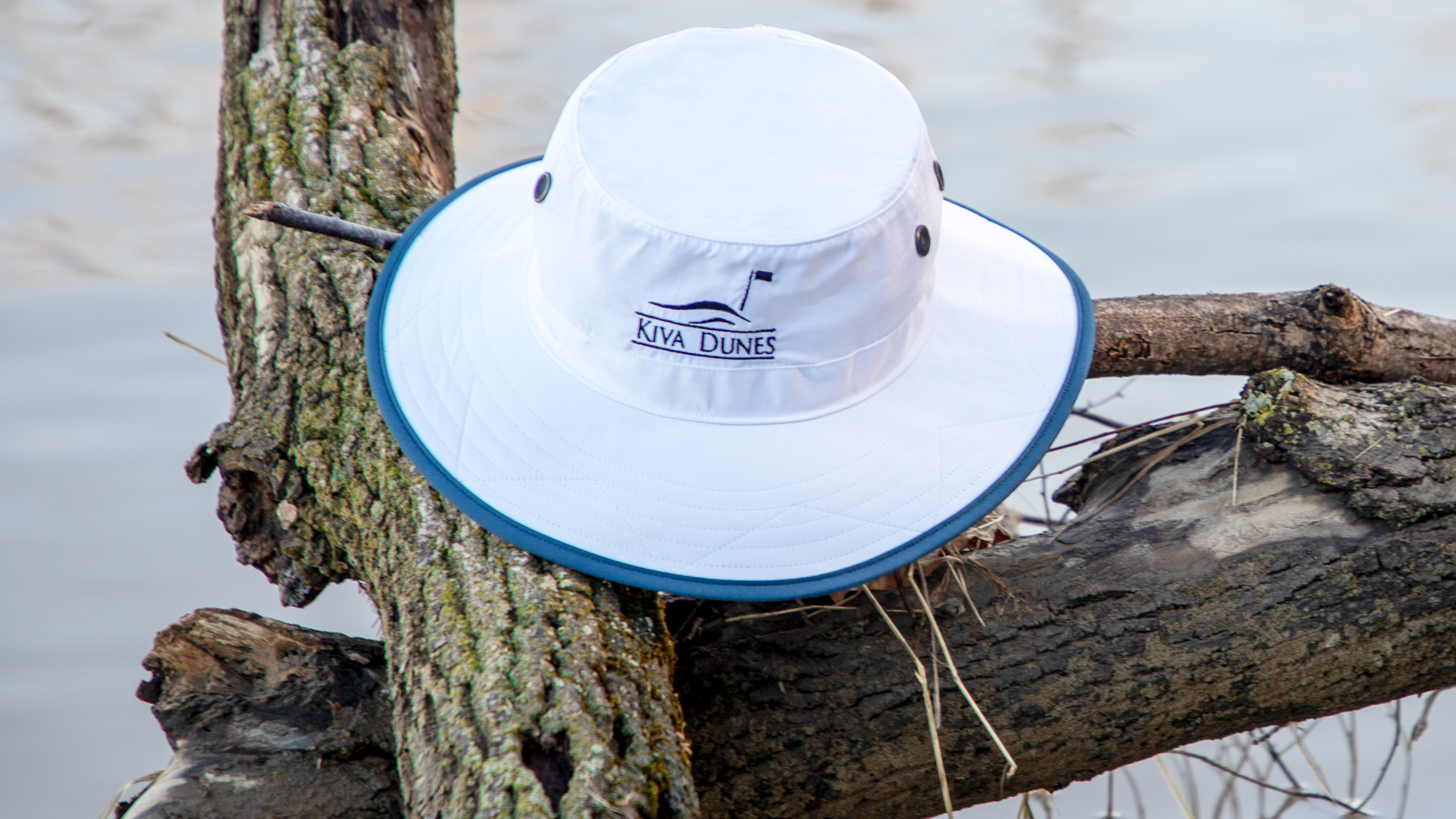 Shademaker I bucket hat sitting on fallen tree branch