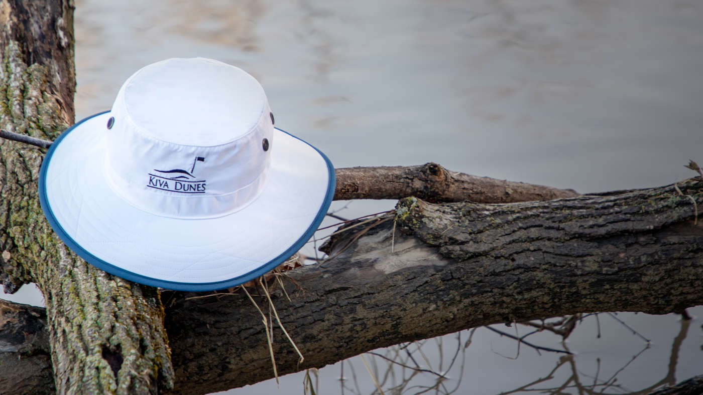 Shademaker I bucket hat sitting on fallen tree branch
