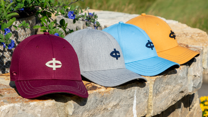 Golf hats sitting on stone wall