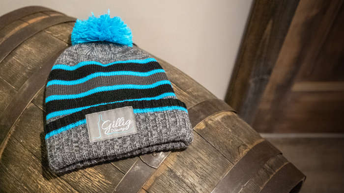 Wineries/Distilleries beanie sitting on solid oak barrel