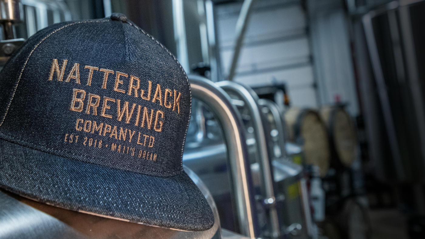 Hats sitting on boxes of bottles