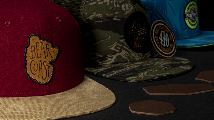 Pukka Logo on a wall surrounded by hanging hats