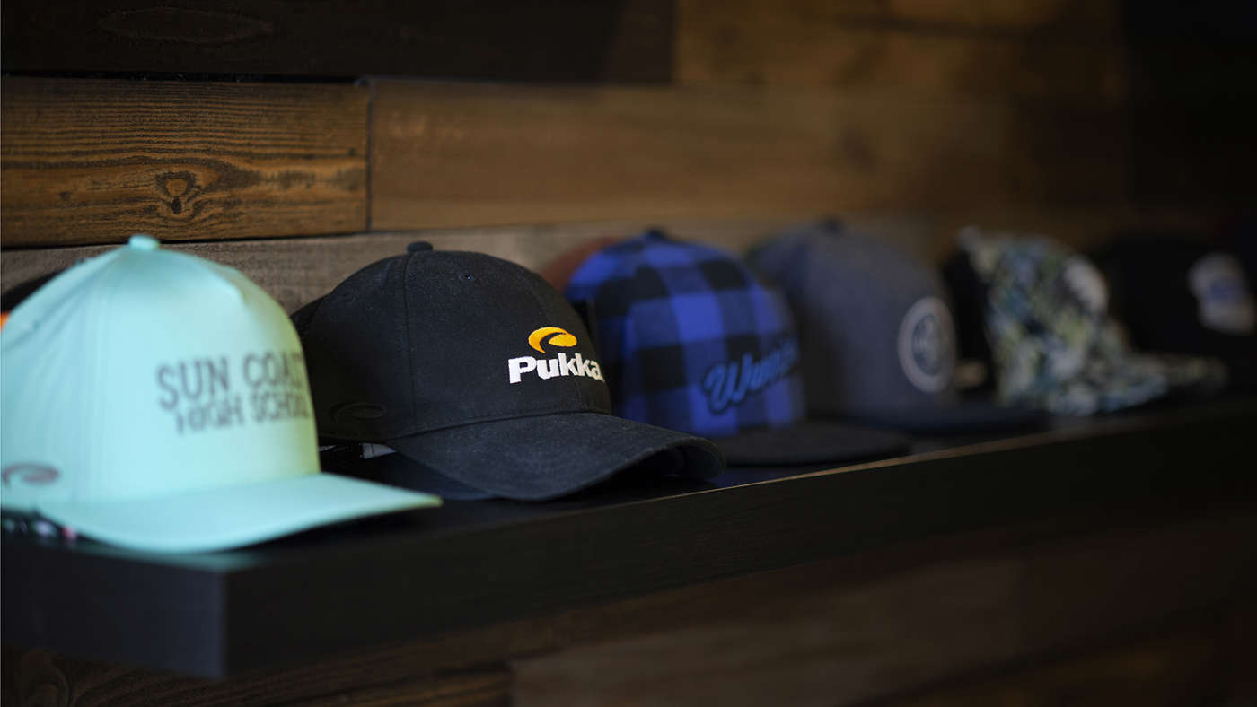 Hats sitting on a shelf in a row