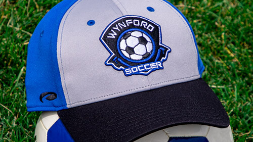 A Soccer hat on top of a soccer ball