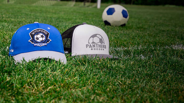 A pair of Soccer hats sitting on the pitch