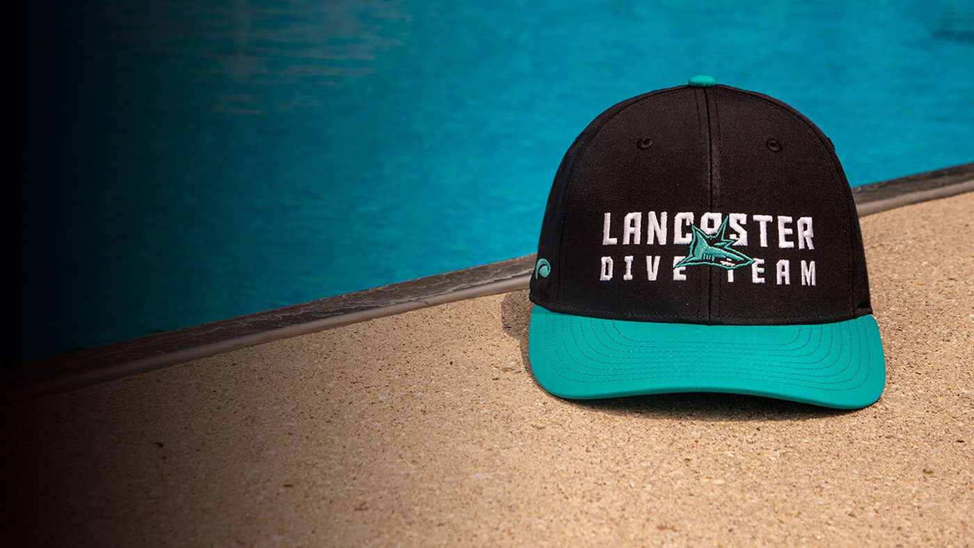 Team Swim & Dive Hat by a pool