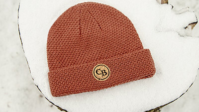 Meridian Knit laying on the snow