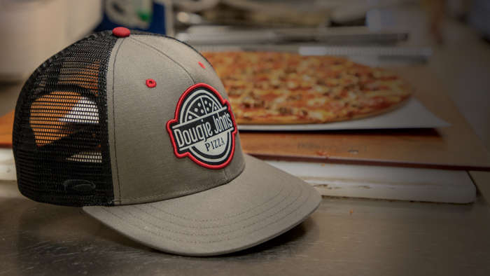 Hat sitting with pizza on work surface