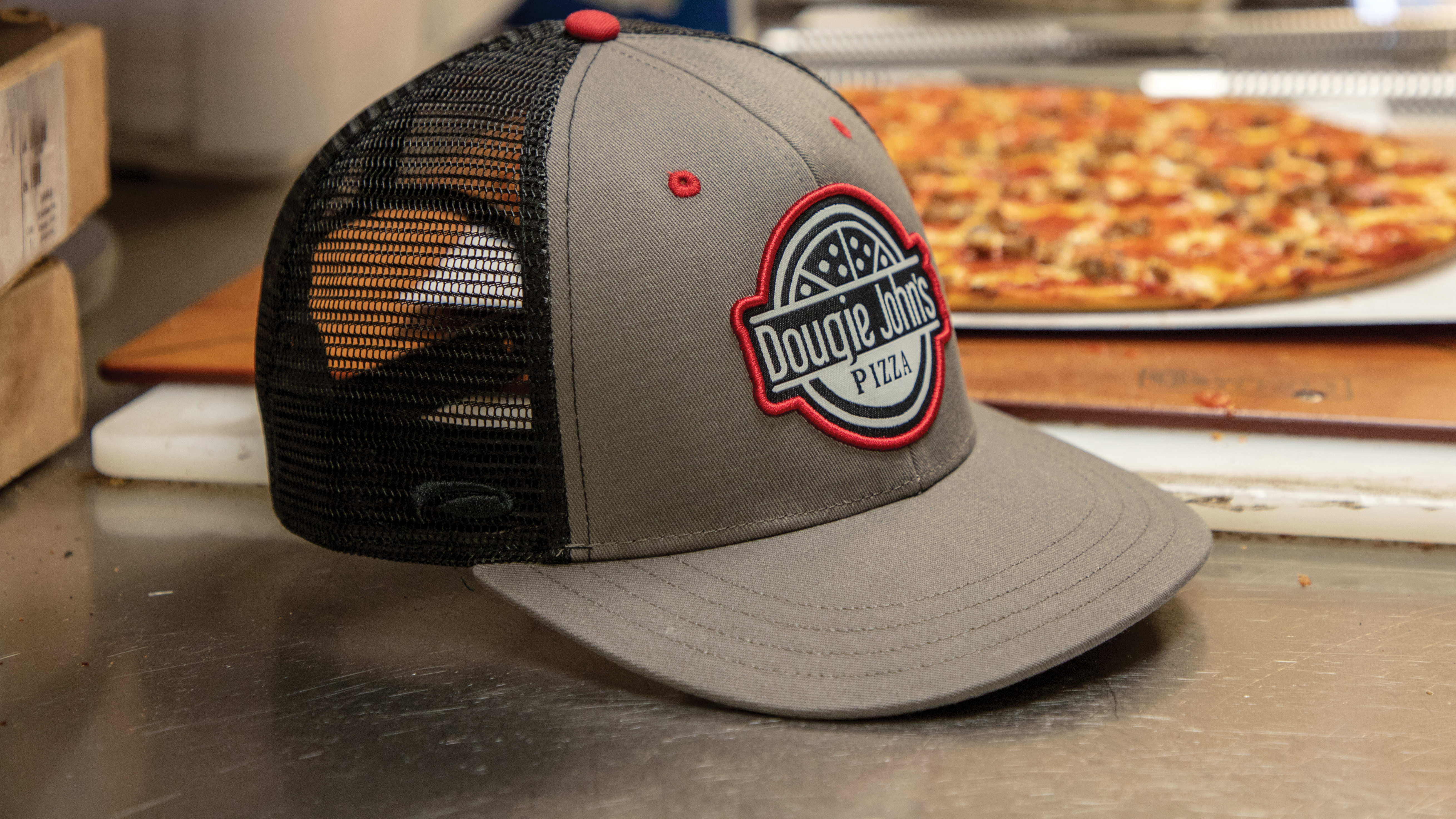 Hat sitting with pizza on work surface