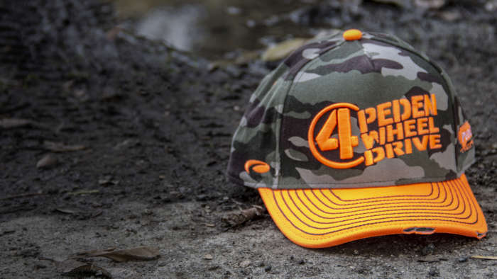 Motorsports hat sitting on dirt track