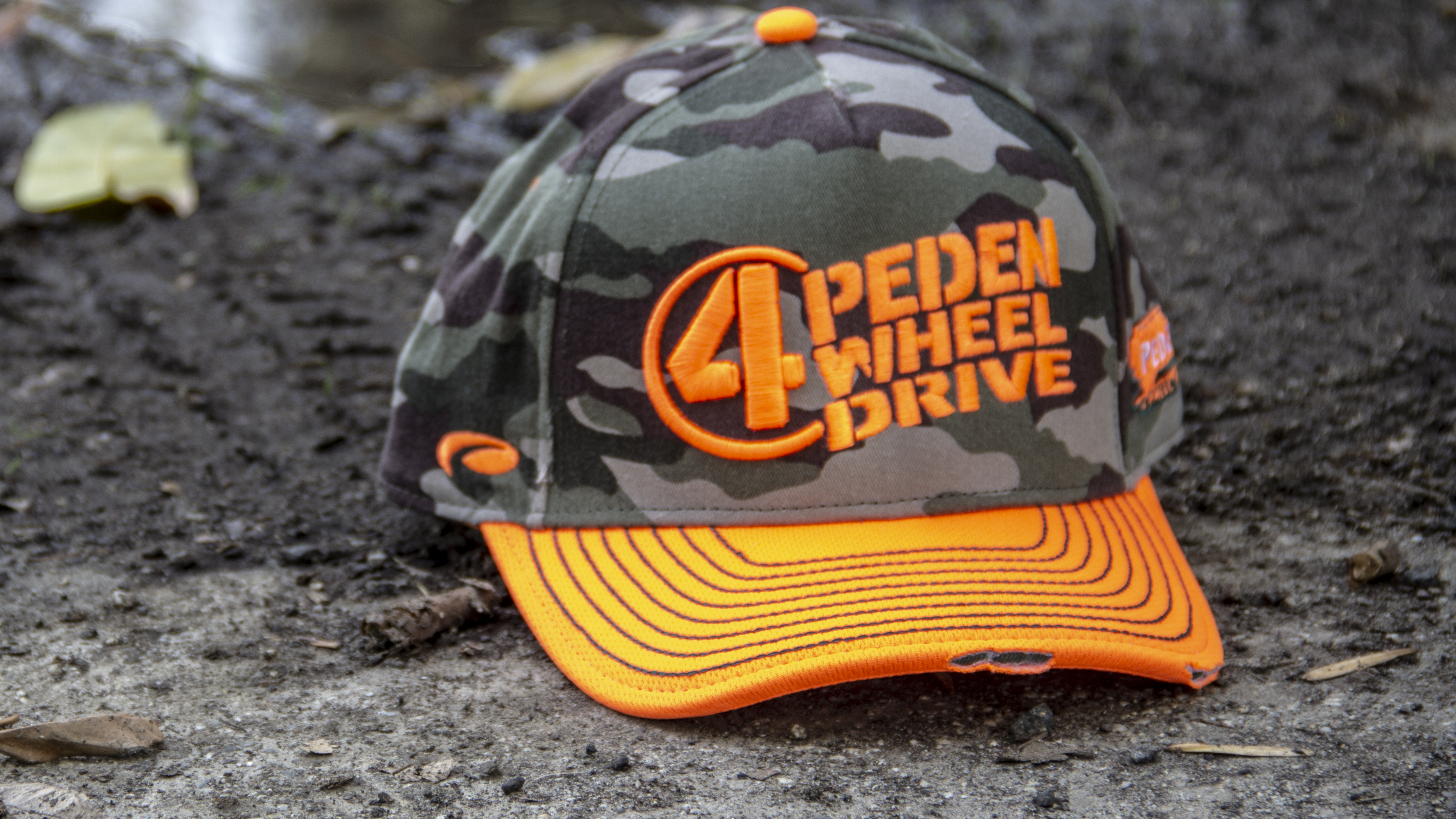 Motorsports hat sitting on dirt track