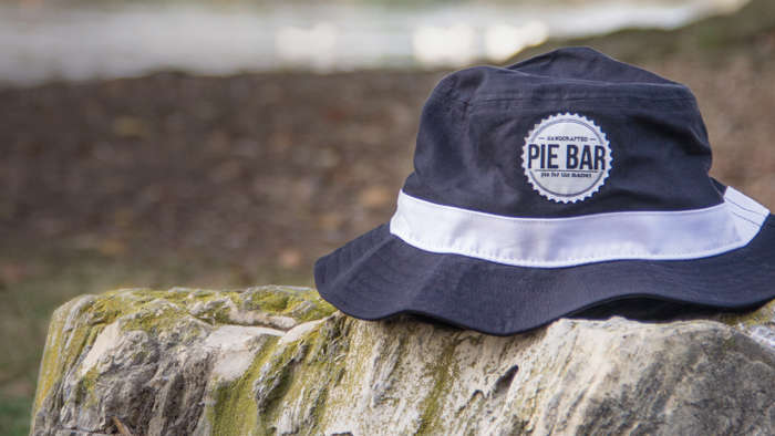 Bucket hat sitting on stone wall