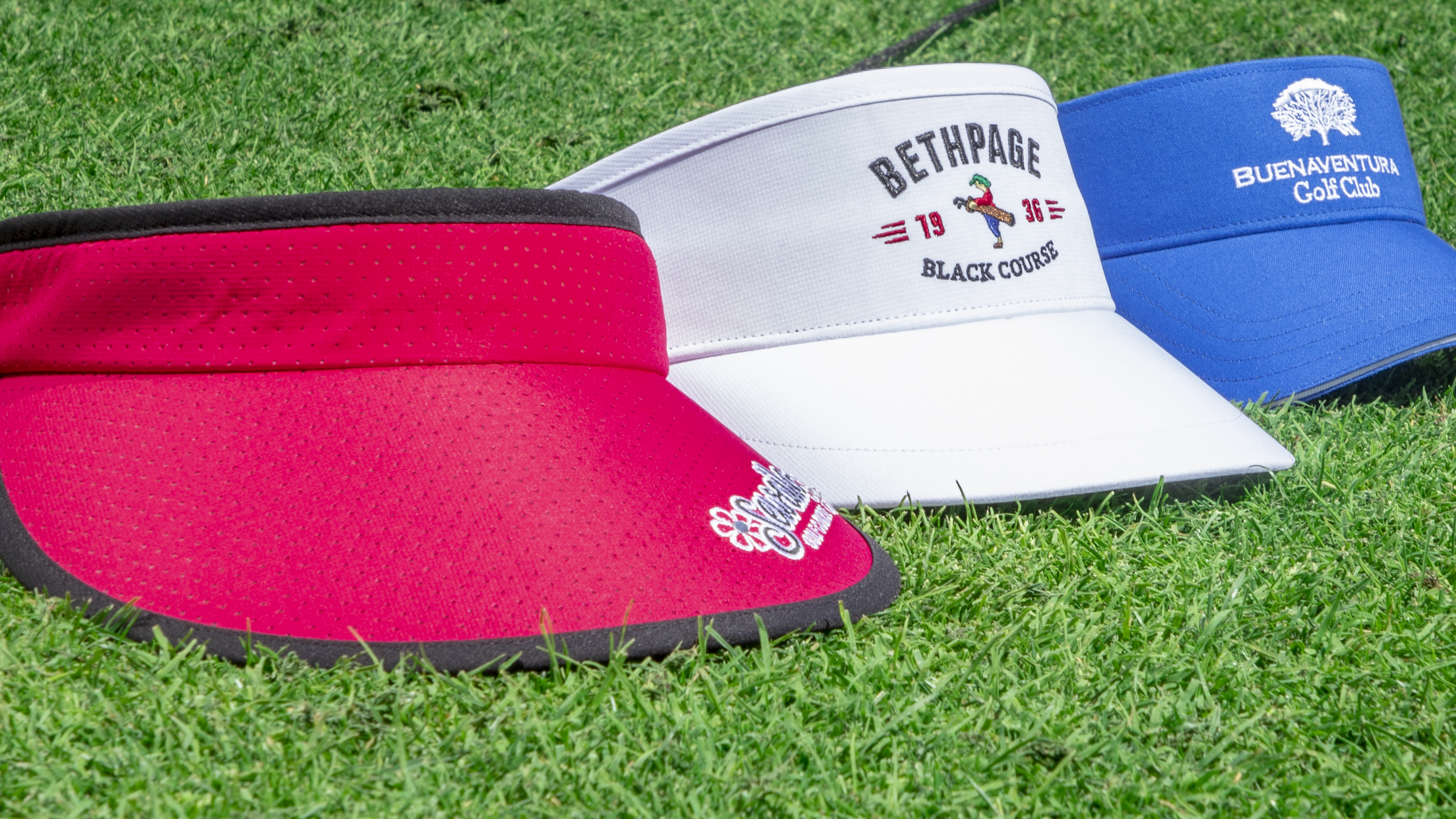 Visors laying on green grass