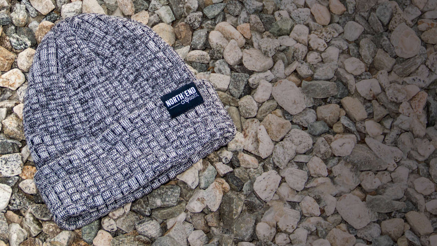 Belafonte Knit laying on a bed of small stones