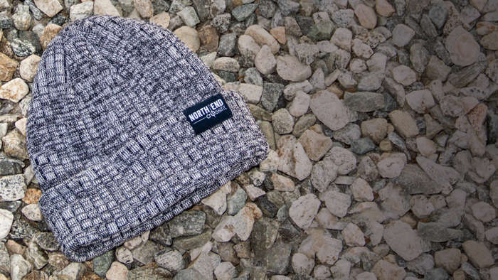 Belafonte Knit laying on a bed of small stones