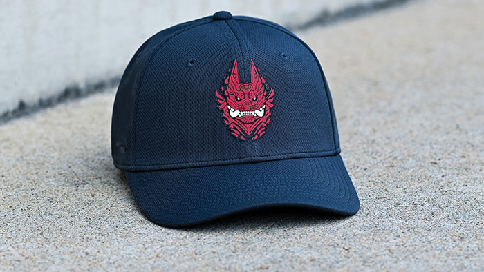 Custom Stretch-Fit Hat by Pukka sitting on concrete