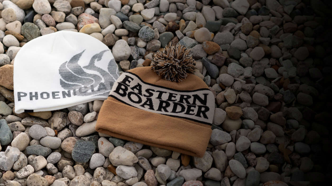 Signature Knits laying on a rock bed